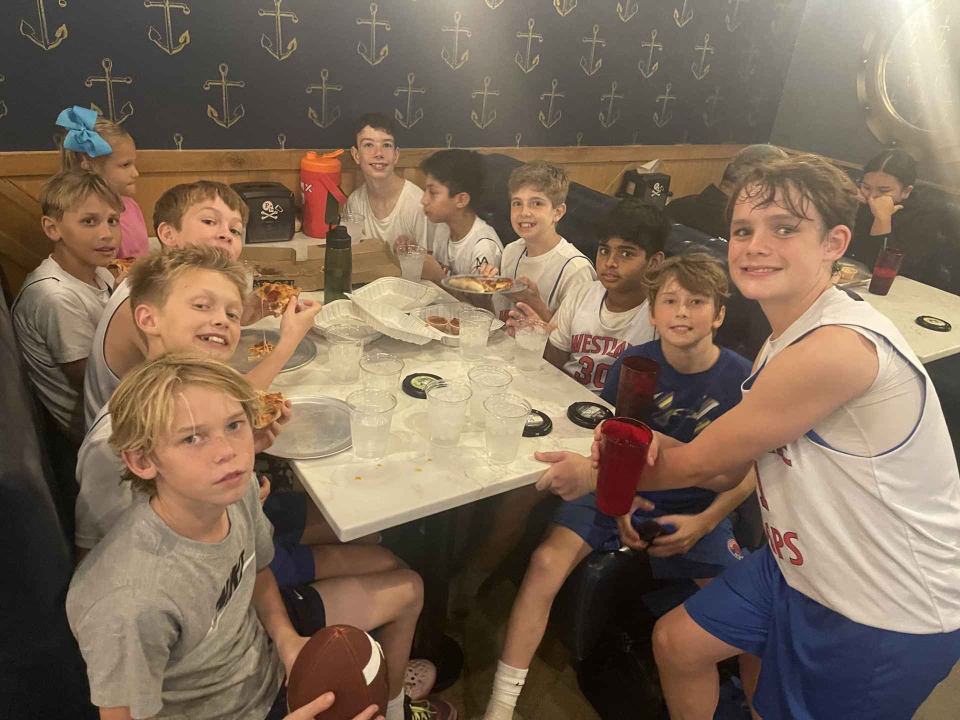 Team celebrating with a post-game pizza party.