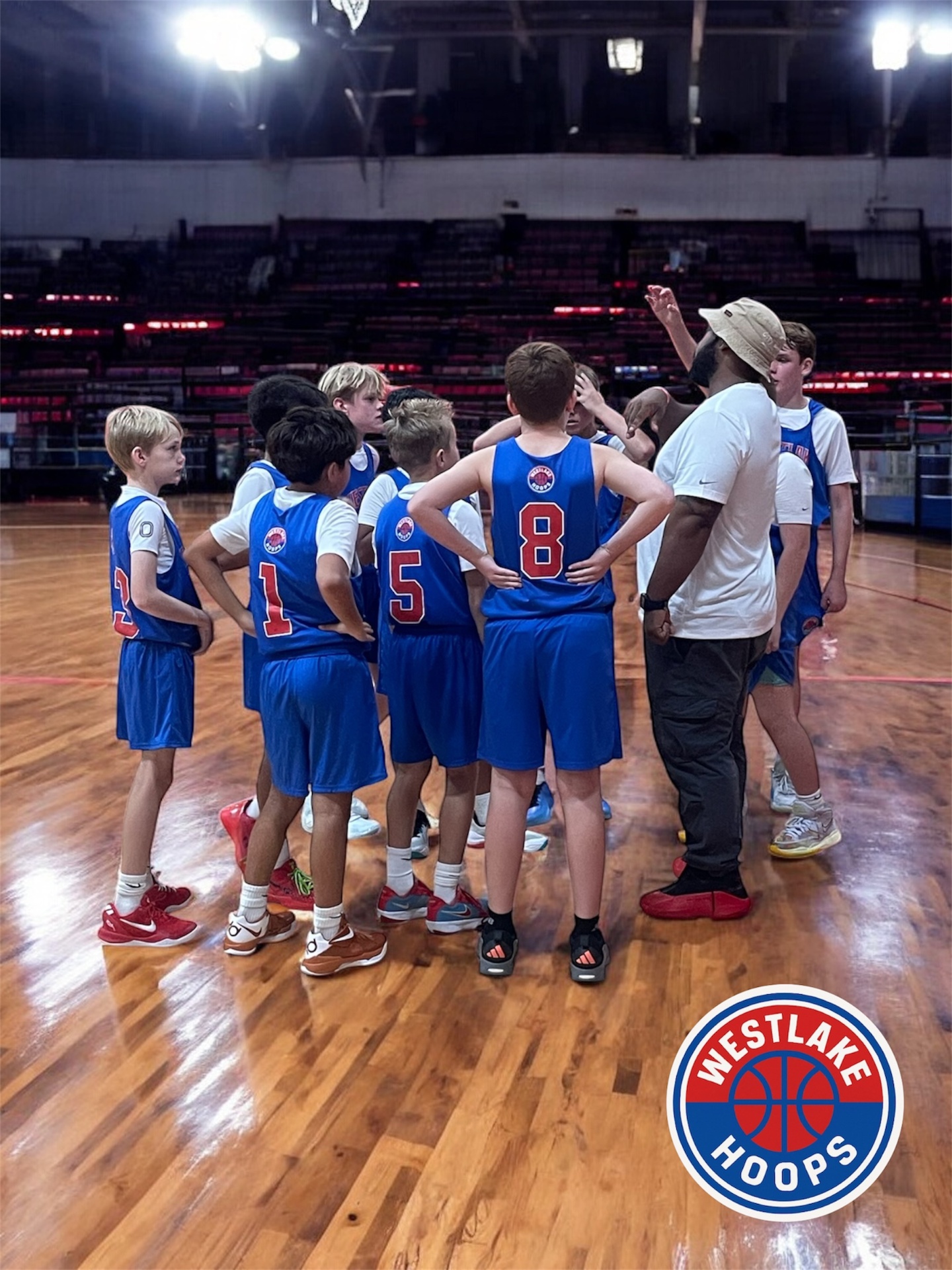 Coach leading a team huddle.
