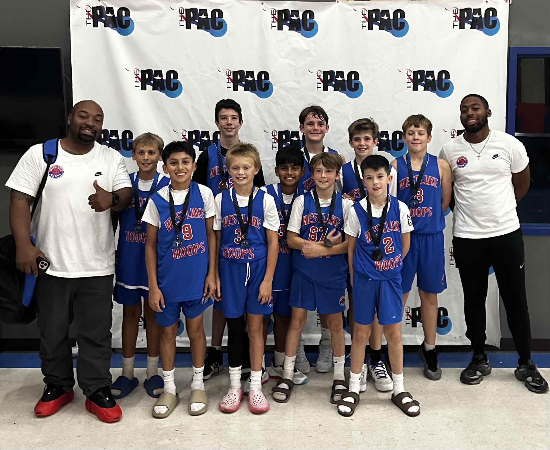 Select team celebrating with medals after a tournament.